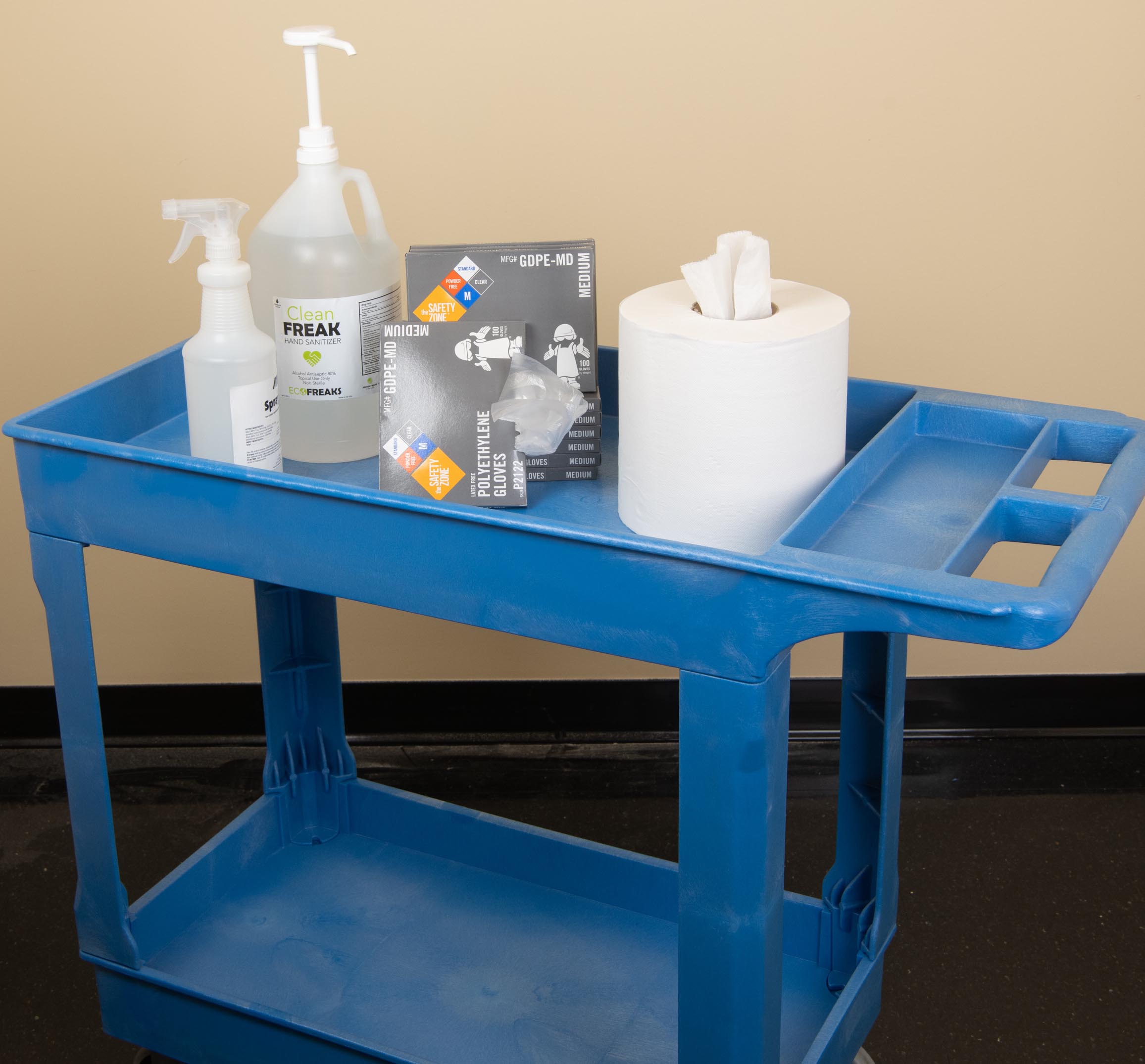 blue cart with paper towels, gloves, cleaning bottles