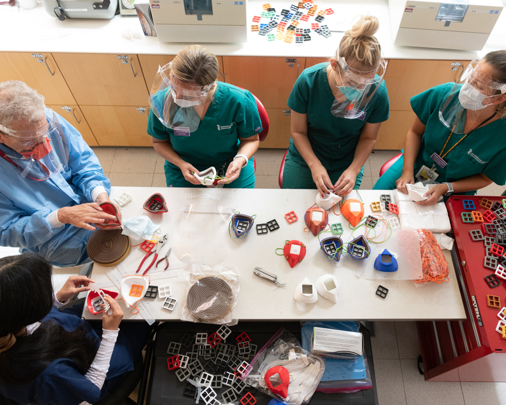 Kate Malchester and other dental students assemble 3-D-printed PPE.