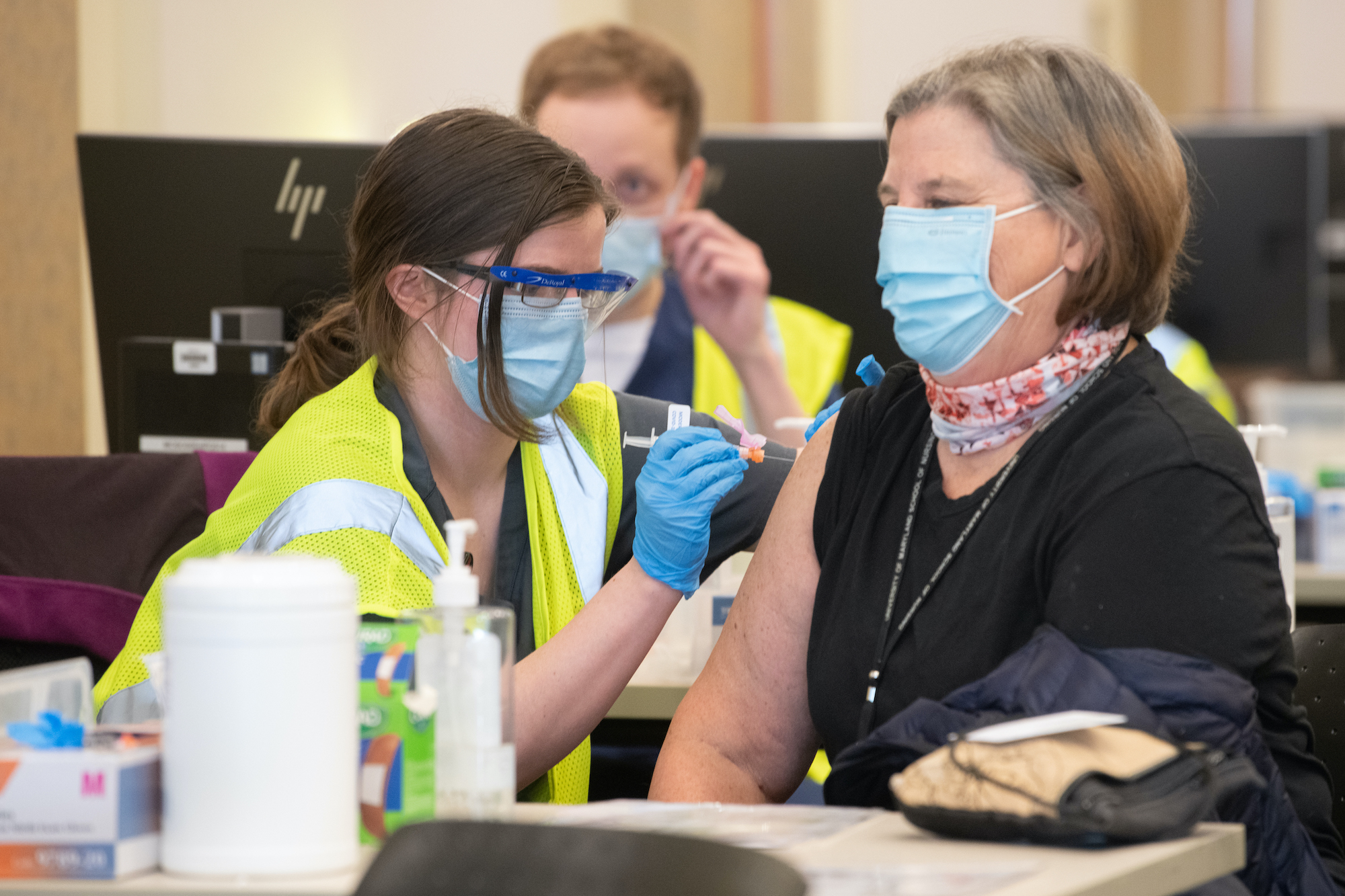 Kelly Doss administering a vaccine 