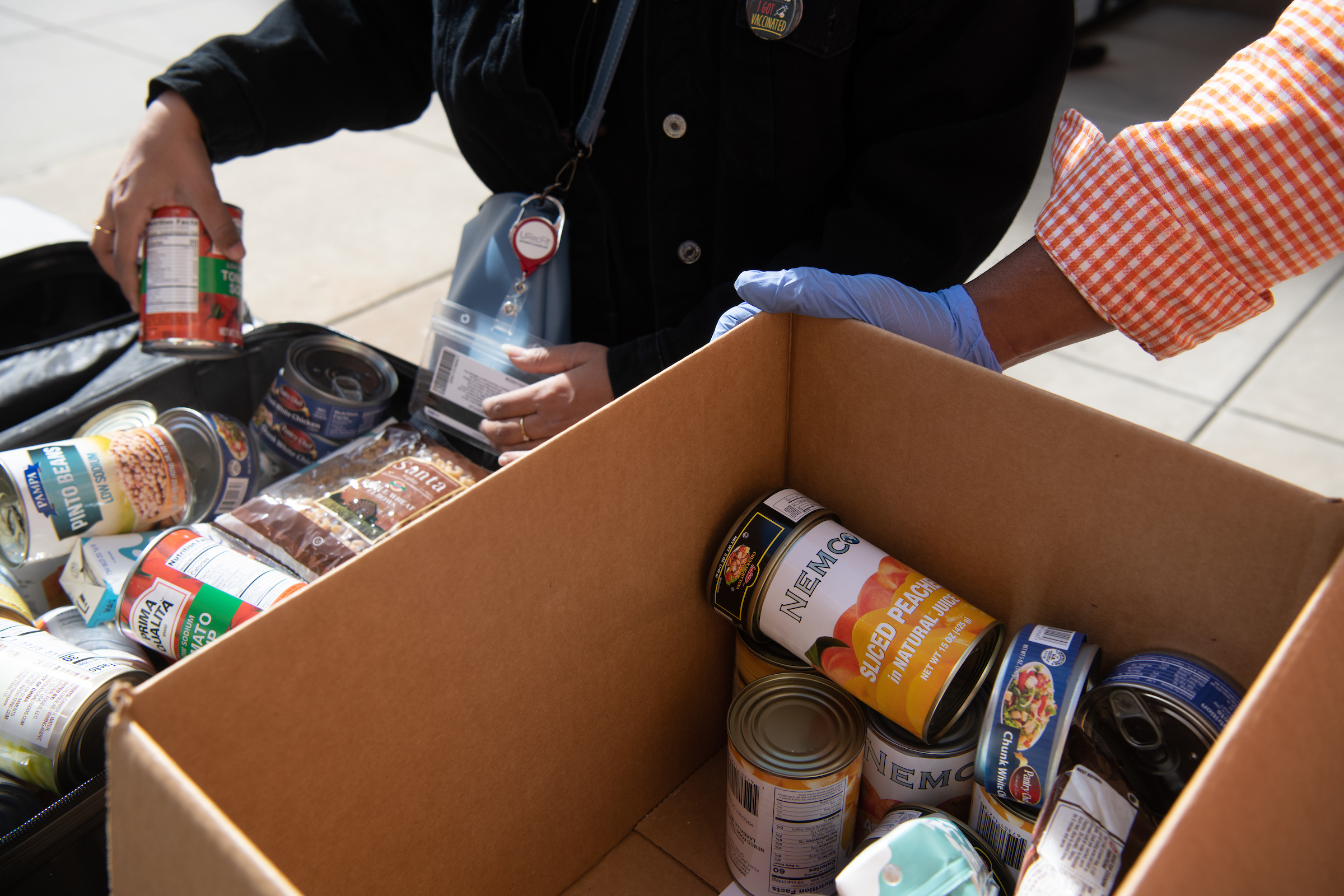 Volunteers put food in boxes