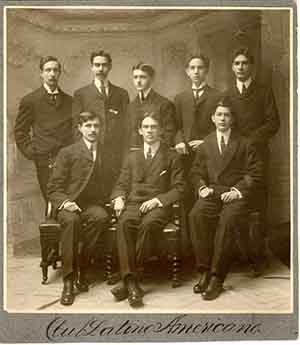 Sepia photograph of a group of men. Five men stand behind three seated men. Photograph from 1904.