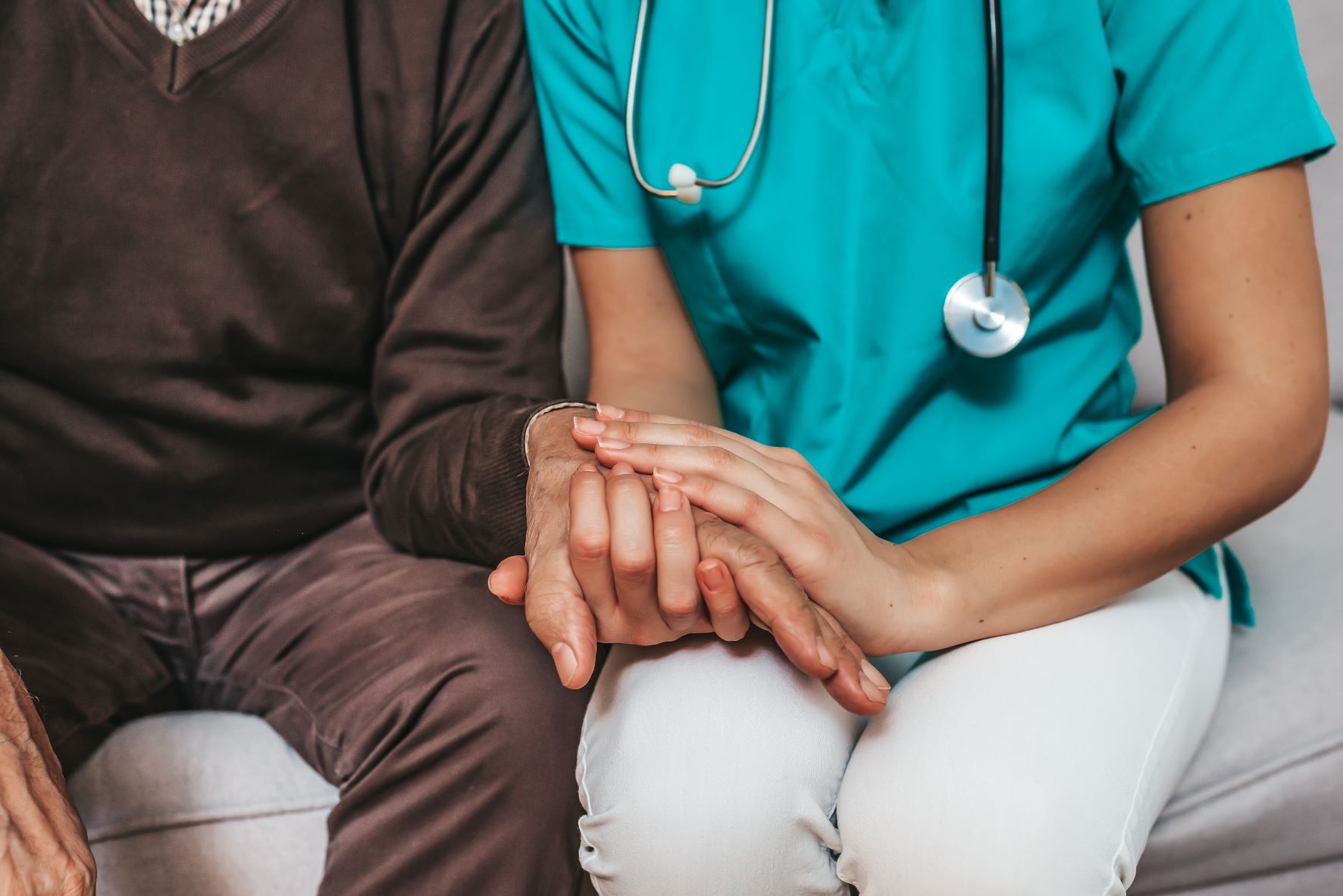 nurse holding patients hand 