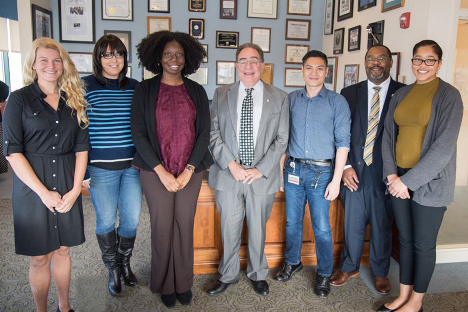 UMB student team from the D.C. Public Health Case Challenge pose for photo with President Jay A. Perman, MD.