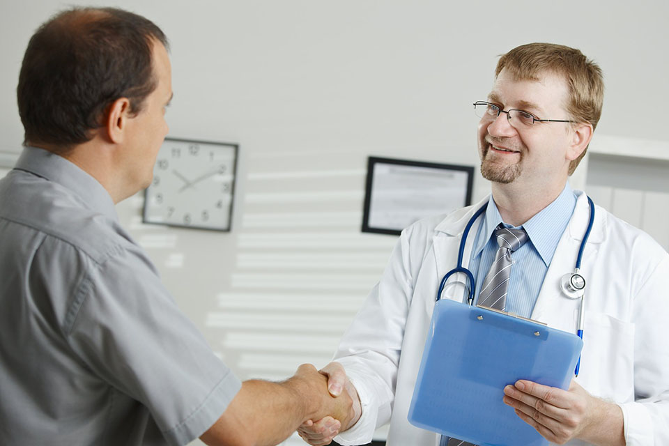 Doctor shakes hand with patient.
