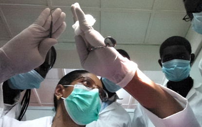Valli Meeks, DDS, MS, RDH, provides instruction to Rwandan dental students