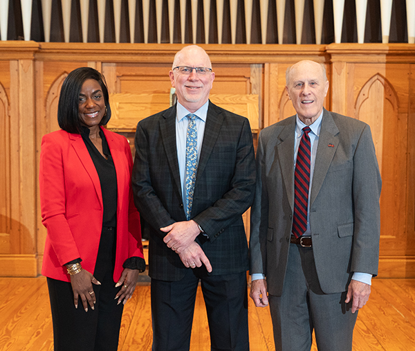 40-year-employee Fred Smith stands between Malika Monger, left, and Bruce Jarrell