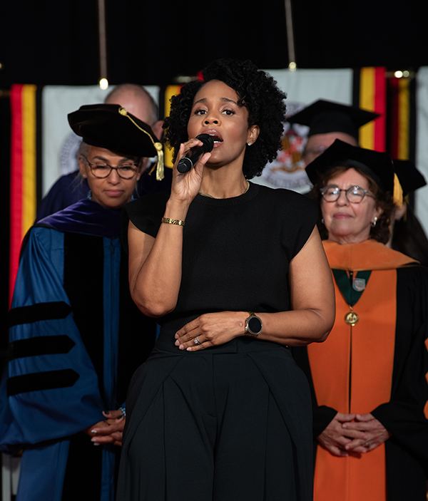 Tiffany White sings the national anthem at UMB Faculty Convocation.