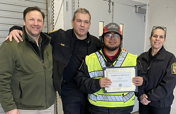 Lt. Brett Etzler, Chief Thomas Leone, security officer Isidro Quinones, and deputy chief Barbara Duncan presenting an award.
