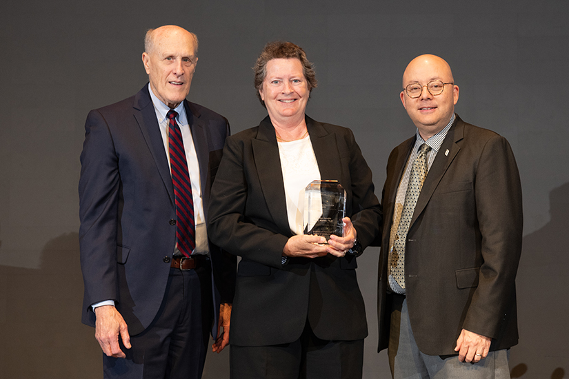 Catalyst for Excellence awardee Cherilyn Hendrix (center) is flanked by UMB President Bruce Jarrell (left) and School of Graduate Studies Dean Kenneth Wong.