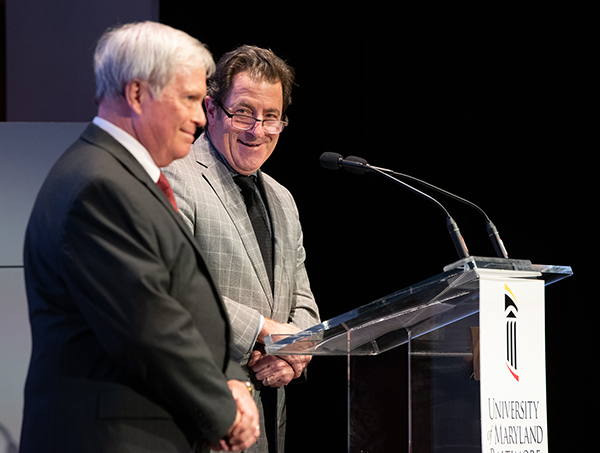 UMSOM Dean Mark Gladwin (right) honored Ludwig J. Eglseder with the school's Catalyst for Excellence award.