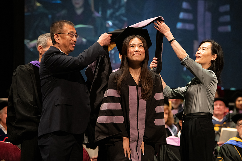 A dental student is hooded at the School of Dentistry Honors Convocation.