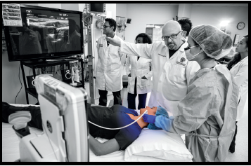 A student uses ultrasound technology to identify the left internal jugular vein for placement of a central line.