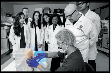 A student demonstrates the placement of an epidural needle on a low-fidelity manikin.