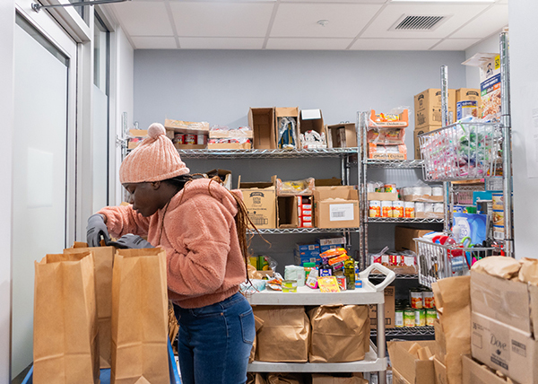 A student sorts food in the UMB Student Pantry