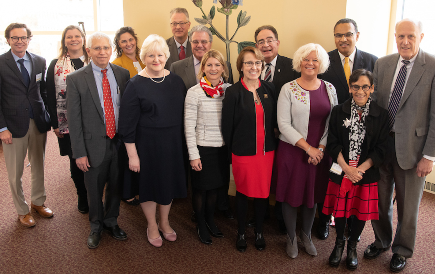 Members of the steering committee that guides the Age-Friendly University partnership between UMB and UMBC gather with leaders of UMB, UMBC, and USM.