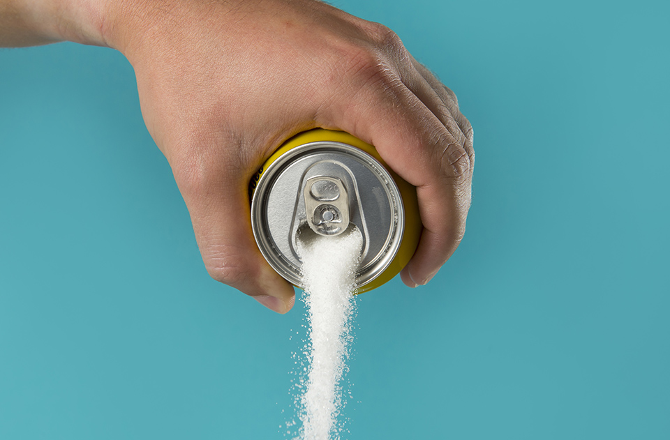 Sugar pouring out of a soda can