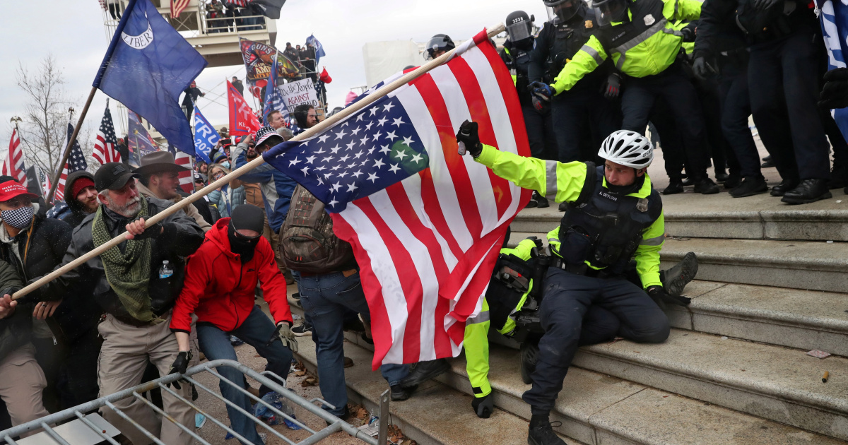 White nationalist attacking police with U.S. flag at the Capitol on Jan. 6 
